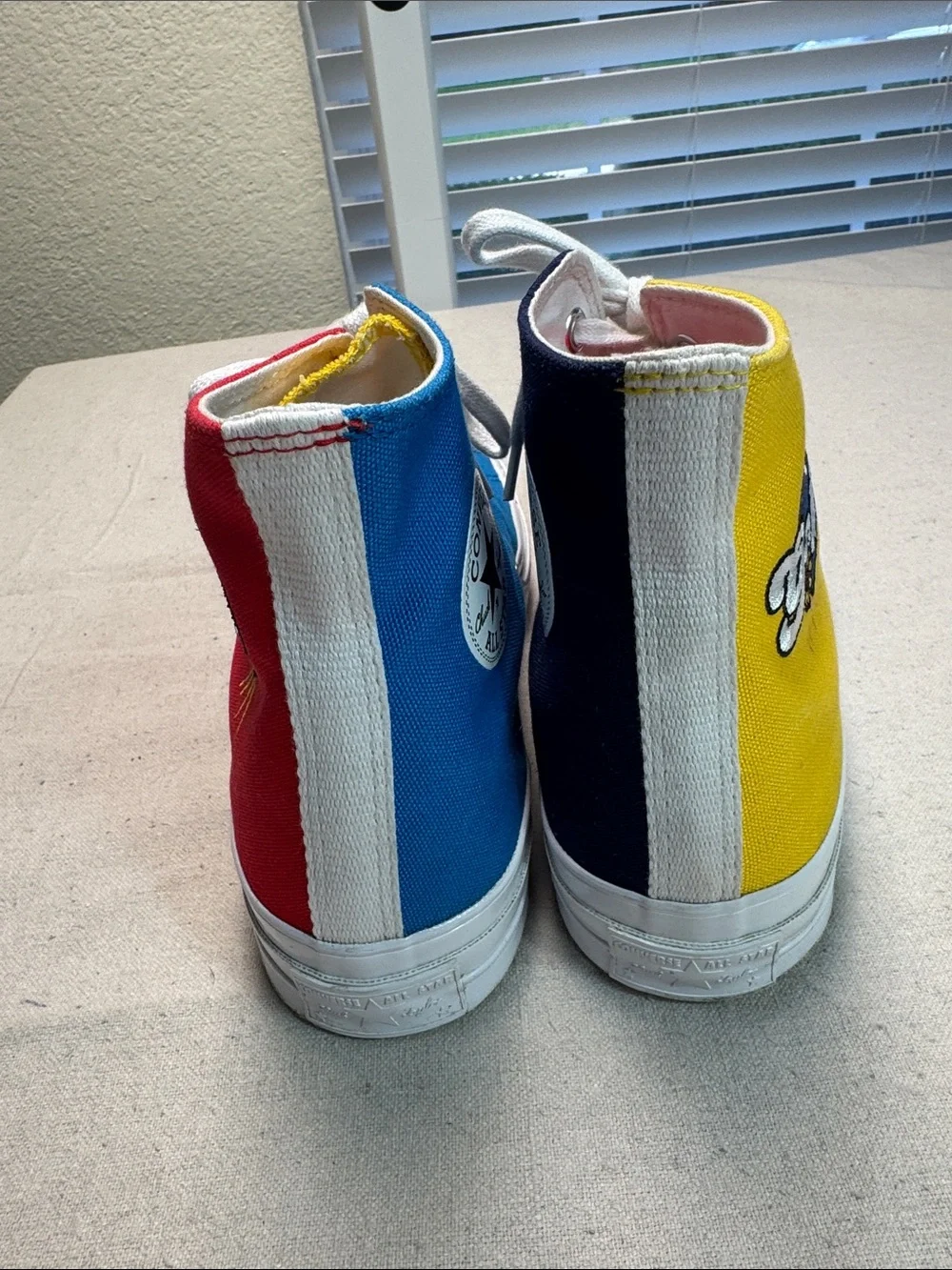Converse All Star Chuck Golf Wang High Top Sneakers in Yellow, Blue, and Red.